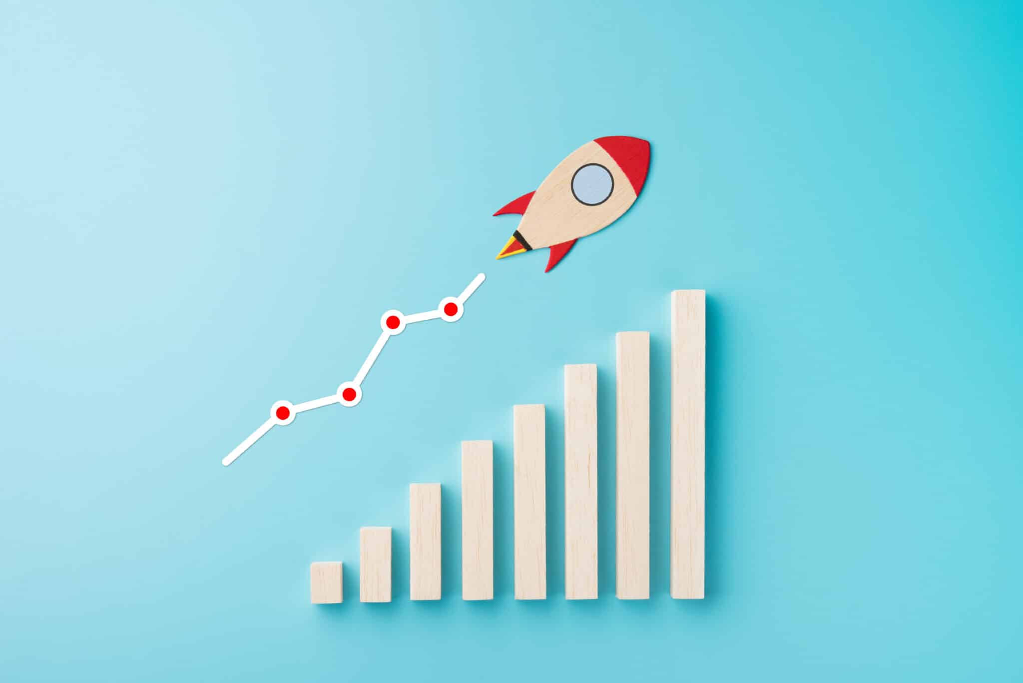 Rocket and chart on blue background business financial start up